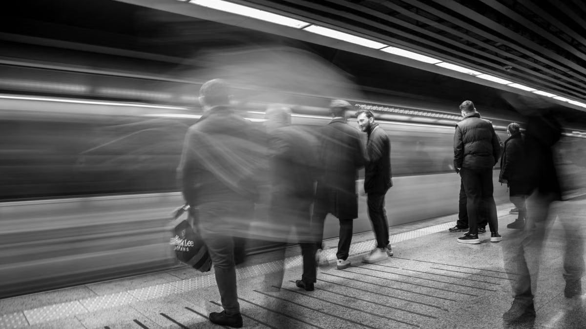 A vivid black and white shot capturing commuters in a busy subway station, emphasizing motion.